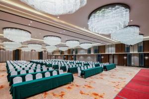 a conference room with chairs and chandeliers at Tanshan Hotel in Shangri-La