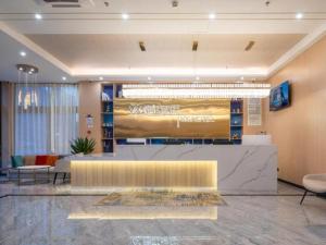 a lobby with a reception desk in a building at VX Hotel Beijing Daxing Wufutang Metro Station Zhongke Dianshanggu in Donggaodi