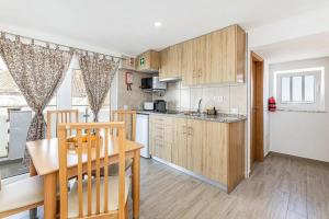 a kitchen with a table and a dining room at Casa da Avó - City Center - Topfloor 360 view apartment in Lagos