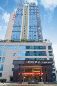 a tall building with a sign in front of it at Echeng Hotel Enshi Minzu Road in Enshi