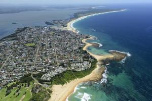 an aerial view of a city next to the ocean at Toowoon Bay Holiday Park in The Entrance