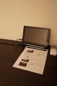 a laptop computer sitting on top of a table at Hotel Miyoshino Annex in Sano