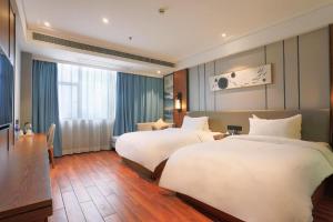 Gulta vai gultas numurā naktsmītnē Starway Hotel Nanchang Qingshanhu High-Tech