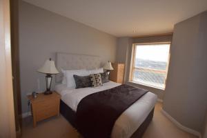 a bedroom with a large bed and a window at The Chambers, Riverside West in Leeds