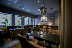 a restaurant with tables and chairs in a room at Scandic Karlstad City in Karlstad