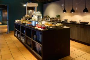 a kitchen with a counter with food on it at Home Hotel Tollboden in Drammen