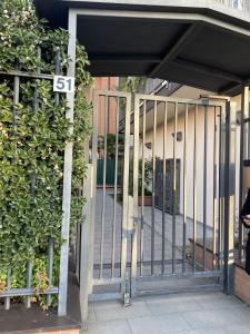 an entrance to a building with a metal gate at Xenia Apartments - Spacious three-room apartment 10 min from Linate in Milan