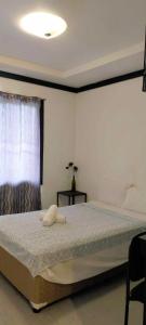 a bedroom with a large bed with a lamp on it at Panglao Bed and Breakfast Exclusive Villa in Panglao