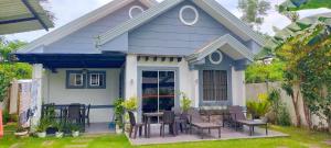 a small blue and white house with a table and chairs at Panglao Bed and Breakfast Exclusive Villa in Panglao