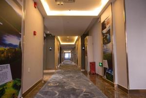 a hallway in a building with a long corridor at Starway Hotel Changji Qitai Bus Station in Xibeiwan