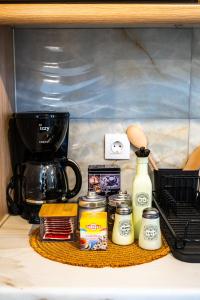 a kitchen counter with a coffee maker and a blender at Margo Cozy Houses in Mavrovouni