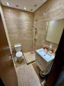 a bathroom with a toilet and a sink and a shower at Golf City Prestigia - Exclusive Apartment in Marrakesh