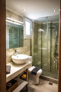 a bathroom with a sink and a shower at Margo Cozy Houses in Mavrovouni +33 photos