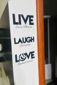 a sign that says live laugh lovebenchlordslords at ModernStudio in Bragadiru