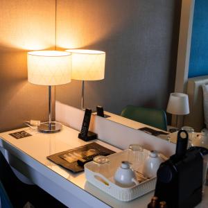 a hotel room with two lamps on a table at The Hotel Unforgettable - Hotel Tiliana by Homoky Hotels & Spa in Budapest