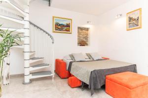 a bedroom with a bed and a stair case at Apartment Nonna Laura in Portorož