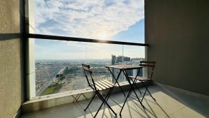 a table and two chairs in a room with a large window at Luxury Studio Apartments Business Bay With Balcony and Free parking by Belvilla in Dubai