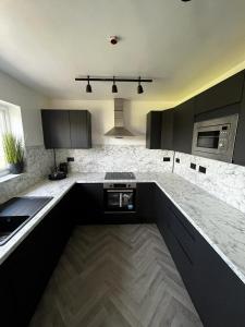 a kitchen with black cabinets and a counter top at North Wales Eco Lodges in Ruthin