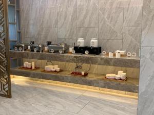 a counter with several machines on it in a room at Starway Hotel Nanchang West Lake Wanda Plaza in Taohua