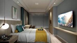 a bedroom with a bed and a tv on a wall at Starway Hotel Nanchang West Lake Wanda Plaza in Taohua