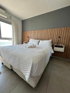a bedroom with a large bed with a white comforter at Departamento en Corrientes in Corrientes