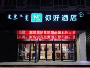 HulunbuirにあるNIHAO Hotel Hailar Zhongyangqiao Ancient Cityの前面にネオンの看板が立つ店
