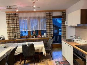 a kitchen with a table and chairs in a room at Spacious holiday home in Niedernsill in Niedernsill