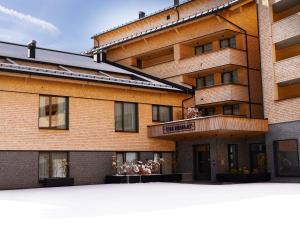 a large brick building with a sign on it at top Apartment on the Arlberg with sauna in Schröcken