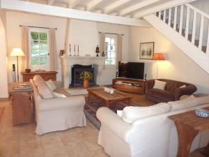 a living room with white furniture and a fireplace at Charming apartment in Oberrieden in Oberrieden