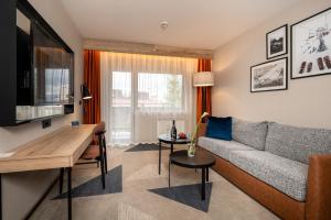 a living room with a couch and a table at Four Points by Sheraton Bansko in Bansko