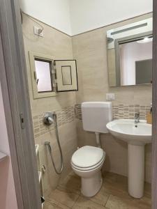 a bathroom with a toilet and a sink at Le Colonne del Massimo Apartment in Palermo