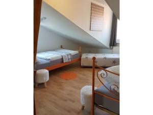 a bedroom with two bunk beds and a staircase at Apartment in Rieseby in Rieseby