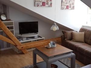 a living room with a couch and a flat screen tv at Apartment in Rieseby in Rieseby
