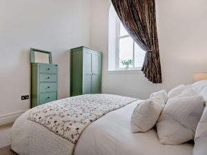 a bedroom with a bed with a window and a dresser at 4 Bed in Middleton-in-teesdale 94274 in Middleton in Teesdale