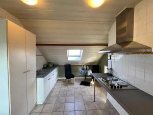 a small kitchen with a sink and a stove at Oneux Village in Theux