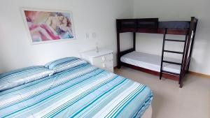 a bedroom with a bed and a bunk bed at Vilage Aconchegante - Imbassaí in Imbassai +27 photos