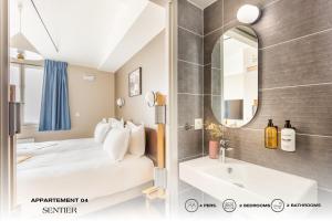 uma casa de banho com uma cama, um lavatório e um espelho. em Beauquartier - Sentier em Paris