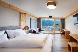 费斯Hotel Tirol Fiss 4Sterne Superior的有两张床和一个阳台的酒店房间