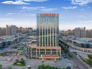 an overhead view of a tall building in a city at Venus Royal Hotel Guangxi Wuzhou Sanqicheng Meiguihu Park in Wuzhou