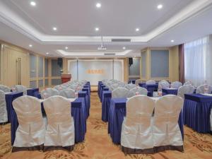 a conference room with blue tables and white chairs at Vienna Hotel Hefei Railway Station Yuanyi Times Plaza in Hefei