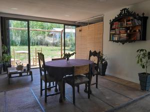 a dining room with a table and chairs and a window at Container House in Cacheuta
