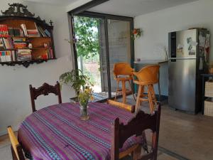 a kitchen with a table and a refrigerator at Container House in Cacheuta