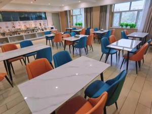 ein Restaurant mit Tischen und Stühlen und eine Cafeteria in der Unterkunft Green Tree Inn Yecheng County Zero Kilometer in Yecheng