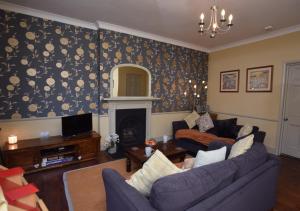 a living room with a couch and a fireplace at Fenkle in Alnwick