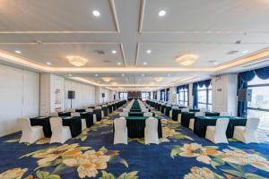 a large room with rows of chairs and tables at Grand Madison Jiujiang Yuexi Lake in Jiujiang