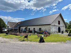 a large white building with chairs in front of it at Valgeranna Apartment in Pärnu