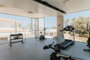 a gym with cardio equipment and a large window at Kampaoh Kikopark Playa in Oliva