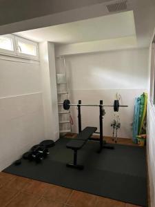 a room with a gym with a bench and weights at Excepcional chalet en Perbes. in Miño +20 photos