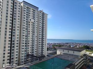 an aerial view of a large apartment building with a swimming pool at Ninety1 Sandakan in Sandakan