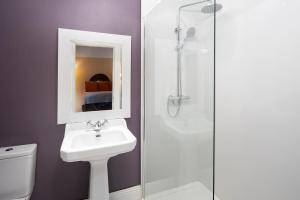 a bathroom with a toilet and a sink and a shower at Barnabrow Country House in Killinagh